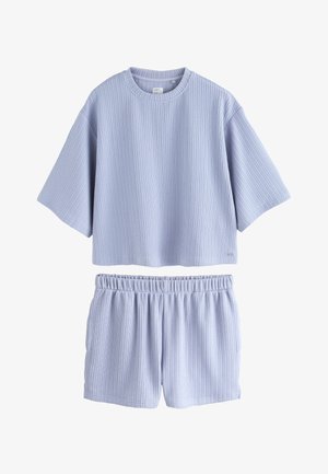 Haut court côtelé bleu clair à manches courtes avec short taille élastique assorti, ensemble présenté sur fond blanc.