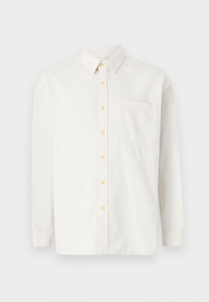 Chemise blanche à manches longues en mélange de coton, avec un col boutonné, des boutons jaunes et une poche poitrine unique. Coupe classique.