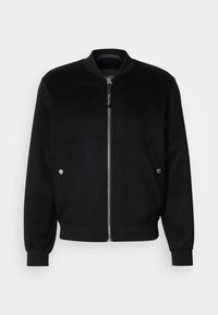Black bomber jacket made of wool blend, featuring a zip front, two side pockets with silver snaps, ribbed cuffs, and a standing collar.