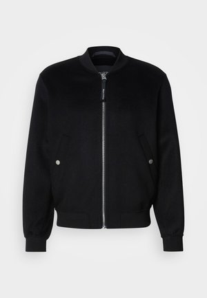 Black bomber jacket made of wool blend, featuring a zip front, two side pockets with silver snaps, ribbed cuffs, and a standing collar.