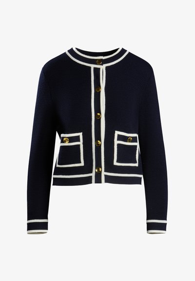 Mornarica pletena jopica z belim robom, s krožnim izrezom in petimi zlatimi gumbi, dvema kvadratnima žepoma z belimi robovi.