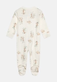 Un body à manches longues, de couleur crème, fabriqué en tissu doux, avec un motif ludique d'animaux et de palmiers dans des couleurs douces.