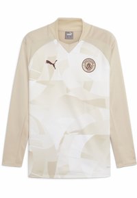 Maillot de soccer à manches longues beige avec des motifs abstraits clairs. Caractérisé par un col en V, le logo Puma et l'emblème de Manchester City en marron foncé.