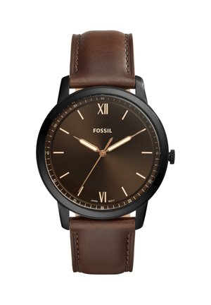 Men's Fossil wristwatch with black round case, brown dial showing 10:10, and brown leather strap with stitching.