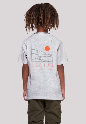 Gray cotton t-shirt featuring a minimalist graphic of mountains and a sun in orange, with the word "ESCAPE" below in bold orange text.