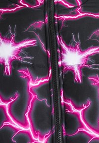 Tissu noir avec une fermeture éclair noire centrale et des motifs d'éclairs rose vif et blanc rayonnant vers l'extérieur.