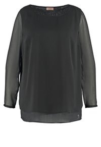 Blouse noire à manches longues avec un décolleté rond, fabriquée en tissu léger et transparent. Présente une coupe droite et un petit accent métallique au bas.