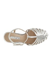 Silver strappy sandal with a woven design and a pointed toe. Features a small heel and an ankle strap for secure fit.