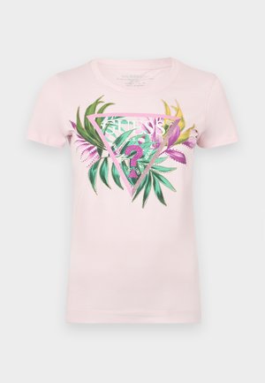T-shirt en coton rose avec un graphique triangulaire comportant un feuillage vert et violet, du texte au centre et des accents pailletés sur le design.