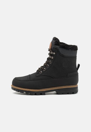 Black waterproof boots with faux fur lining, round toe, and rubber sole. Features metallic eyelets and a textured ankle collar.