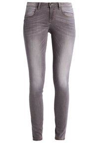 Úzké džíny v bledě šedém denimu, s předními kapsami, zipovým zapínáním a jemným texturováním v oblasti stehen.
