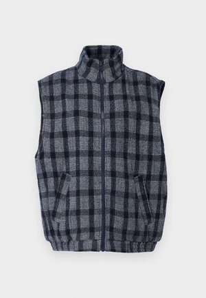 Navy i sivi karirani prsluk s visokim ovratnikom, zatvaračem na cipelu, dva prednja džepa i teksturiranom tkaninom. Elastična suknja na struku.