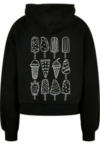 Felpa corta nera con un grafichetta bianca che raffigura vari dolci gelati disposti in due file, inclusi coni e ghiaccioli.