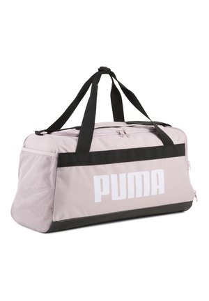Lyserød Puma rejsetaske med sorte håndtag, sort bundkant, sidelommer i net og stort hvidt Puma-logo på frontpanelet.