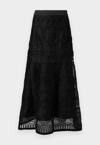 Jupe midi noire en tissu de dentelle superposée avec des détails de broderie florale et géométrique.