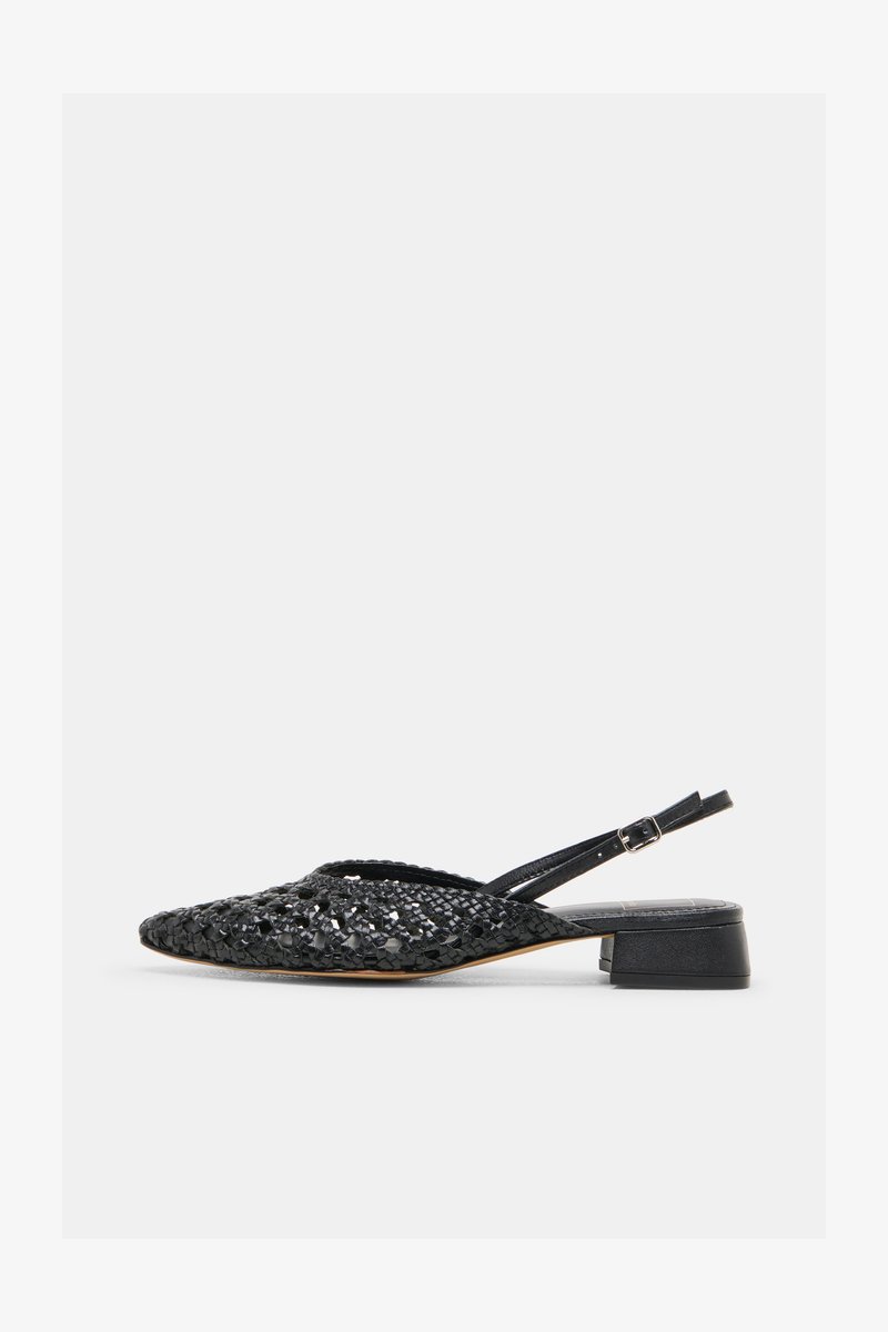 Μαύρο πλεκτό δερμάτινο παπούτσι slingback με χαμηλό τετράγωνο τακούνι και ρυθμιζόμενο λουράκι με αγκράφα, φωτογραφημένο από το πλάι σε λευκό φόντο.