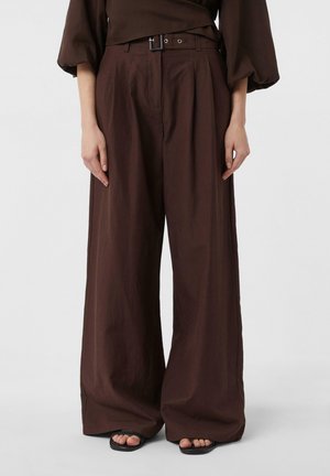 Brown wide-leg trousers made of lightweight fabric, featuring a belted high waist, front pleats, and a smooth texture.