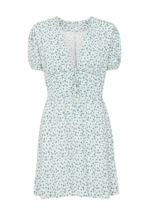 Vestito corto bianco con piccolo motivo floreale blu, maniche a sbuffo, scollatura a V profonda e dettaglio con nodo frontale sul busto.