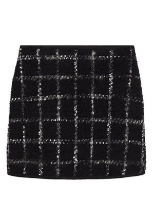 Sort tekstureret mininederdel med hvidt ternet mønster og diskrete glitrede detaljer.