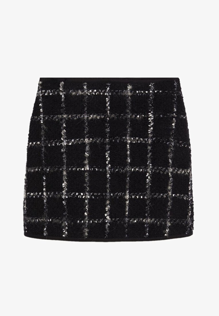 Mini-jupe noire texturée avec un motif à carreaux blanc et des détails subtils pailletés.
