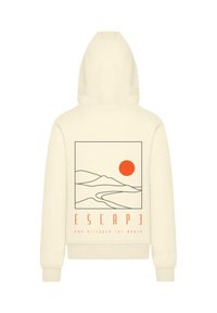 Crème kleurige hoodie met een grafisch ontwerp van heuvels en een zon in oranje en zwarte omtrek, met de tekst "ESCAPE AND DISCOVER THE WORLD."