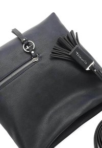 Borsa in pelle nera con chiusura a zip, dettaglio in metallo circolare e accentuazione con nappina. Include una tracolla removibile. Superficie texturizzata.