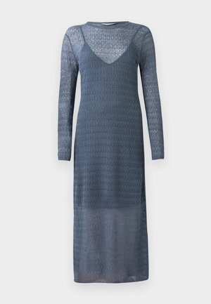 Long-sleeve, blue knit dress with a textured pattern, deep V-neckline, and sheer fabric. Floor-length design with a fitted bodice.