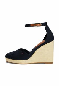 Navy canvas wedge shoes with an open toe, ankle strap, and a beige woven platform. Features a small logo accent on the front.