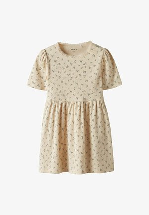 Knee-length beige dress with short sleeves and a ribbed texture, adorned with a floral pattern and a gathered skirt. It has a scalloped neckline and puffed sleeves.