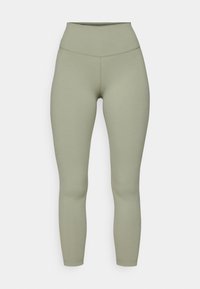 Legginsy z wysokim stanem w stonowanym oliwkowym kolorze, wykonane z elastycznego materiału, z bezszwową konstrukcją i dopasowanym krojem.