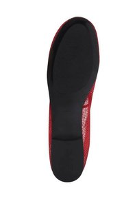 Red textured upper shoe with a flexible black rubber sole, featuring a smooth surface and rounded shape for comfort and fit.