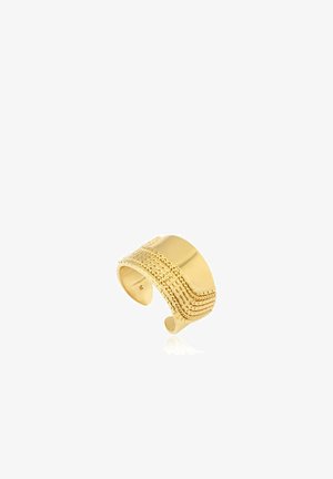 Large bague manchette en or avec motifs ondulés texturés et ponctués complexes, ouverte pour un ajustement réglable.