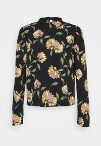 Pitkähihaisen mustan paidan kuvioissa on keltaisia, valkoisia ja purppuranvärisiä kukkia. Paidassa on korkea kaulus ja hieman rento istuvuus.