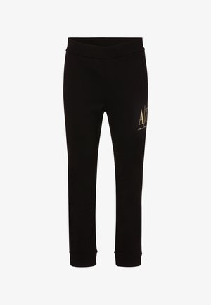 Mustat verkkarit, joissa on sileä pinta ja joustava vyötärö, ja vasemmassa reidessä on kultainen logo.