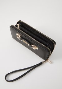 Black leather wallet with gold-tone accents, featuring a zip closure, wrist strap, and multiple interior compartments for organization.