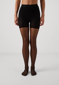 Collants opacos pretos com padrão de bolinhas, apresentando textura suave, design sem costuras e cintura alta para maior conforto.