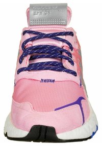 Scarpa sportiva rosa con tomaia in tessuto testurizzato, lacci e dettagli viola, linguetta imbottita e suola bianca con battistrada nera.