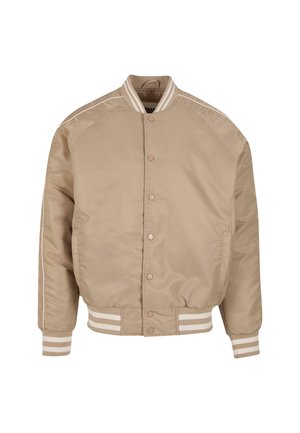 Bežinė bomber tipo striukė su lygiu, blizgiu paviršiumi. Savybės: balti raukiniai ant apykaklės ir rankogalių, taip pat mygtukų užsegimas.