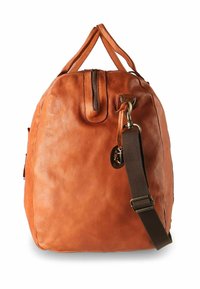 Sac à dos en cuir orange-brun avec une finition texturée. Il comporte une fermeture éclair supérieure, des poignées courtes et une bandoulière sombre amovible avec des accents métalliques.