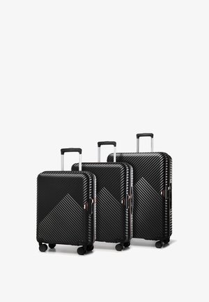 Set of three black hard-shell suitcases with diagonal ridges, rose gold accents, retractable handles, and four wheels each.