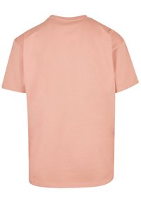 Pink cotton t-shirt featuring a round neck, short sleeves, and a smooth texture. Back view shows plain design with no patterns or accents.