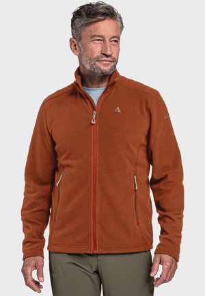Rostfarbener Fleece-Jacke mit hohem Kragen, Reißverschluss vorne und zwei seitlichen Taschen, mit dezenter Markierung auf der Schulter.