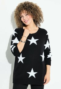 Schwarzer Pullover mit weißen Sternmustern, aus weichem Material, mit Rundhalsausschnitt und gerippten Bündchen und Saum.