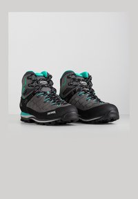 Zwarte en grijze wandelschoenen met turquoise accenten. Gelaagd bovenwerk, verstevigde neus en gevoerde rubberen zool. Bevat metalen oogjes en veters.