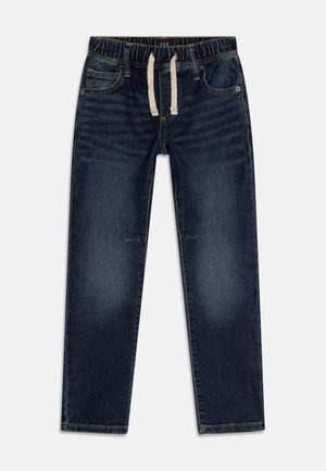 Mørkeblå denimbukser med elastisk talje og hvid snøre, forlommer og subtilt falmet detaljer på lår og knæ.