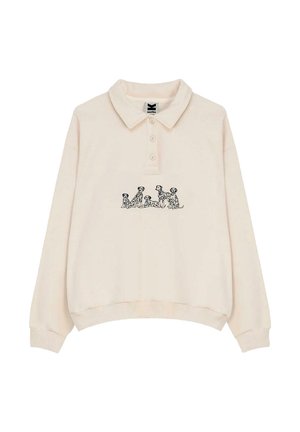 Suéter tipo polo color crema con cuello, que presenta un gráfico de un perro negro en el frente. Hecho de tela suave con puños y dobladillo acanalados.