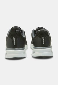 Black athletic shoes with a mesh upper, featuring a white midsole and a gray outsole. "Power" branding on heel tab.