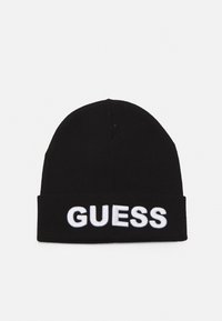 Bonnet en tricot noir arborant le mot "GUESS" en broderie blanche en gras sur l'avant. Design simple avec un ajustement snug et sans embellissements.