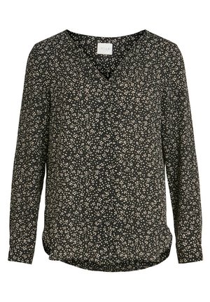Blouse noire à manches longues avec un décolleté en V, présentant un motif tacheté blanc sur l'ensemble. Fabriquée en tissu lisse avec un ourlet légèrement arrondi.
