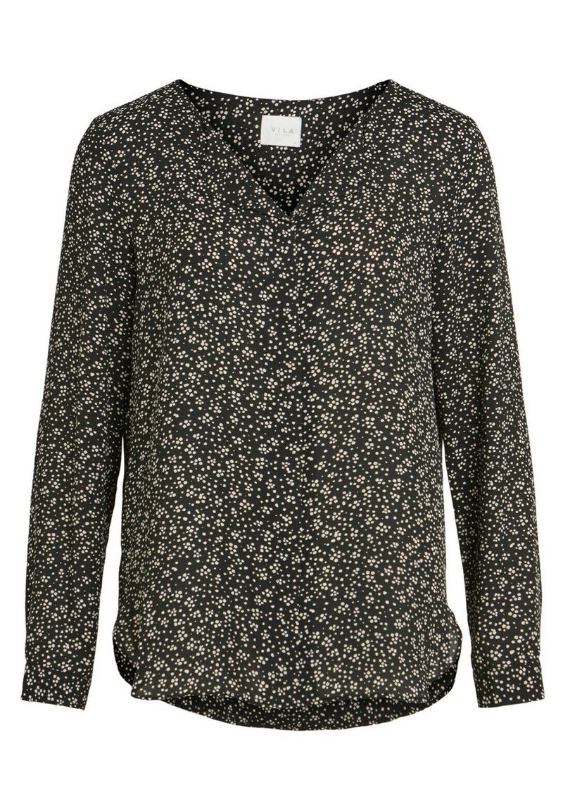 Svart långärmad blus med V-ringning, med ett vitt prickigt mönster genom hela plagget. Tillverkad av ett mjukt tyg med en lätt rundad nederkant.